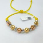 PULSO TEJIDO CON 13 BALINES DE ORO 18K EN HILO AMARILLO