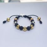 PULSO TEJIDO CON 9 BALINES DE ORO 18K CON BOLAS DE NEOPRENO EN HILO NEGRO