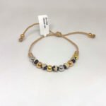 PULSO TEJIDO CON 8 BALINES DE ORO 18K CON BOLAS DE NEOPRENO EN HILO BEIGE