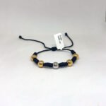 PULSO TEJIDO CON 5 BALINES DE TRES ORO 18K CON 6 NUDOS EN HILO NEGRO