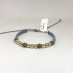 PULSO TEJIDO CON 9 BALINES DE TRES ORO 18K CON BOLAS DE NEOPRENO EN HILO GRIS