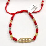 PULSO TEJIDO CON HERRAJE AUDI, 14 BALINES DE ORO 18K BOLAS DE NEOPRENOCON HILO ROJO