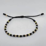 PULSO TEJIDO CON 21 BALINES DE ORO 18K EN HILO NEGRO CON BALINES NEOPRENO