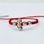 PULSO TEJIDO CON 6 BALINES DE ORO BLANCO 18K EN HILO ROJO