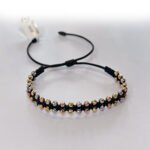 PULSO TEJIDO CON 48 BALINES DE ORO 18K TEJIDO DOBLE EN HILO NEGRO