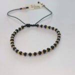 PULSO TEJIDO CON 34 BALINES DE ORO 18K CON BOLAS DE NEOPRENO EN HILO NEGRO