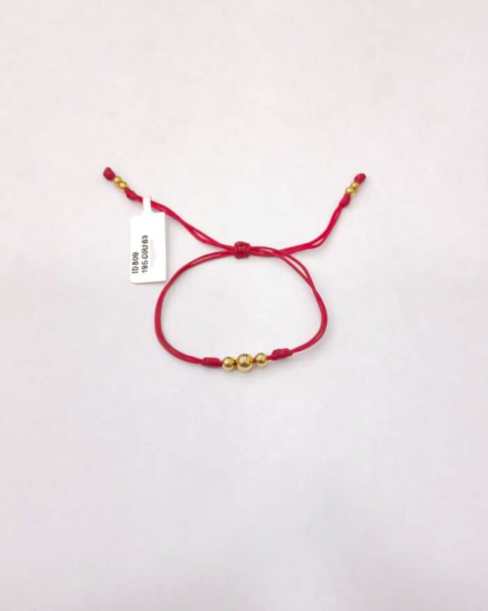 PULSO TEJIDO CON 7 BALINES DE ORO 18K DOS NUDOS EN HILO ROJO - Image 1