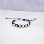 PULSO TEJIDO CON 8 BOLAS DE ORO 18K