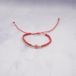 PULSO TEJIDO CON OJO TURCO Y  4 BALINES ORO BLANCO  18K