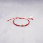 PULSO TEJIDO CON OJO TURCO Y  4 BALINES ORO BLANCO  18K