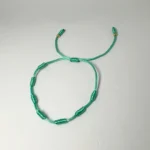 PULSO TEJIDO CON 7 NUDOS EN COLOR TURQUESA CON 2 BALINES DE ORO 18K