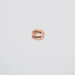 DIJE SEPARADOR PIEDRAS NEGRAS ORO ROSA 18K