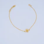 PULSO DE TEJIDO ROLÓN CARA FELIZ EN ORO 18K